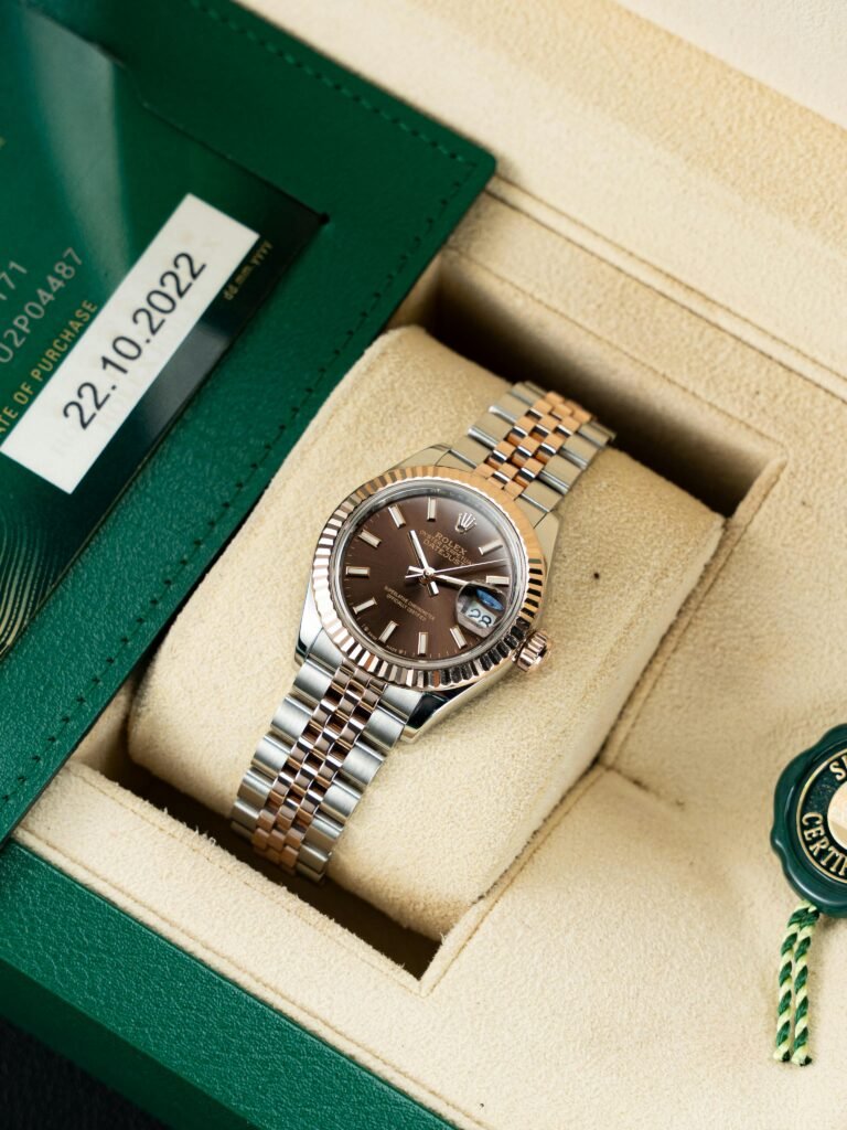 Elegant silver and gold watch in a luxury box with certificate detail, perfect gift idea.